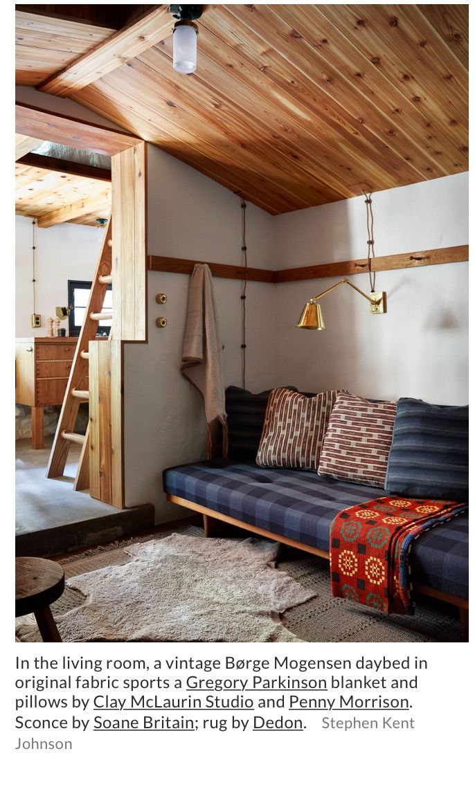 a living room filled with furniture and a ladder