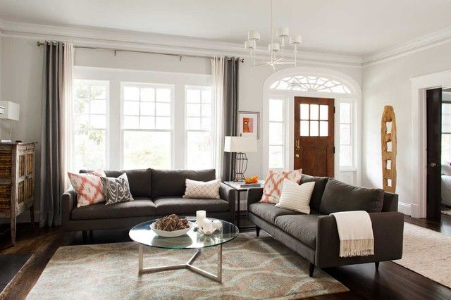 a living room with two couches and a coffee table in front of the window