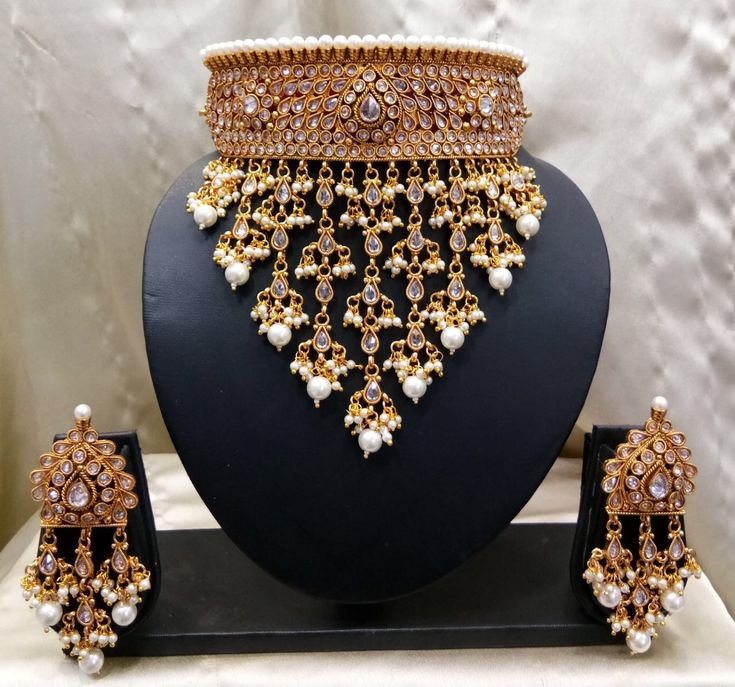 an elaborate necklace and earring set on display