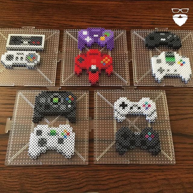 four pixelated video game controllers sitting on top of a table