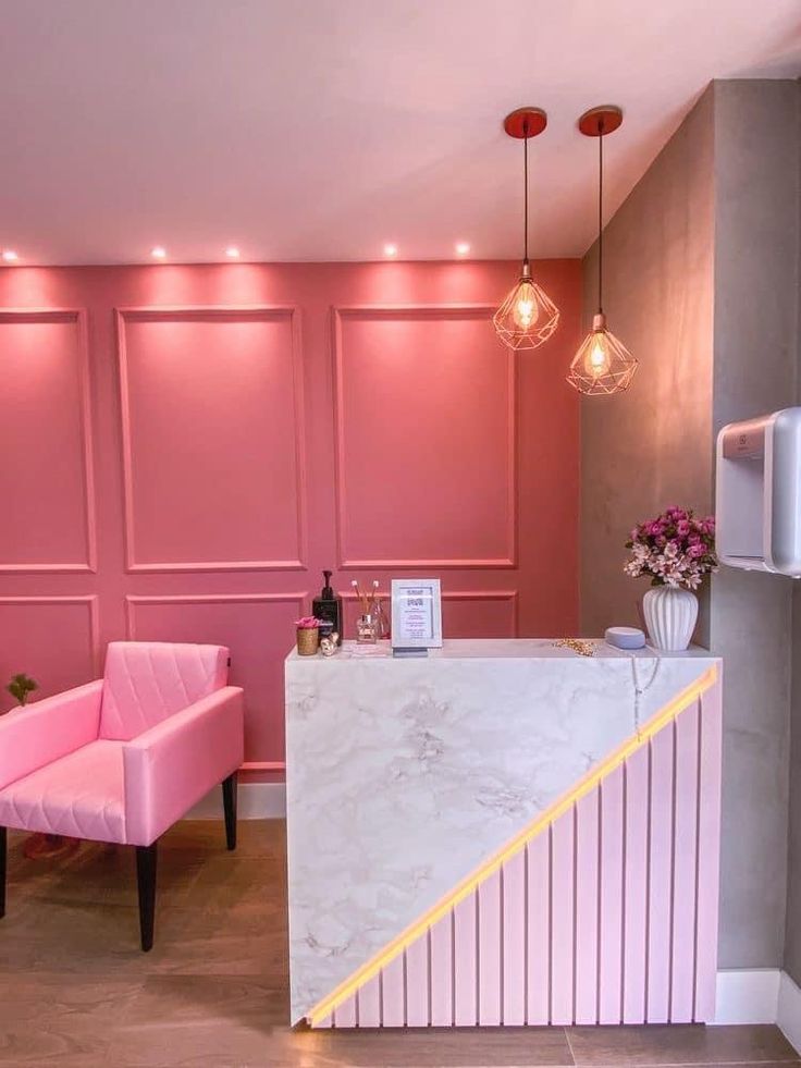 a pink chair sitting next to a counter in a room