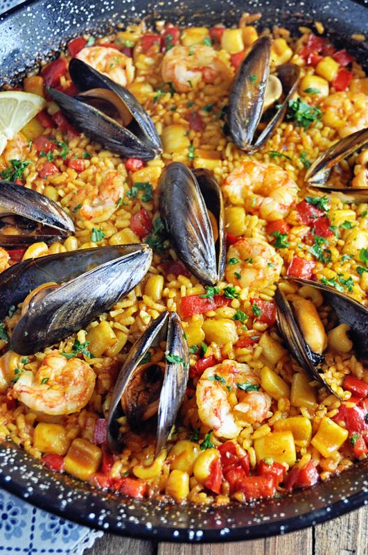 a skillet filled with seafood and rice