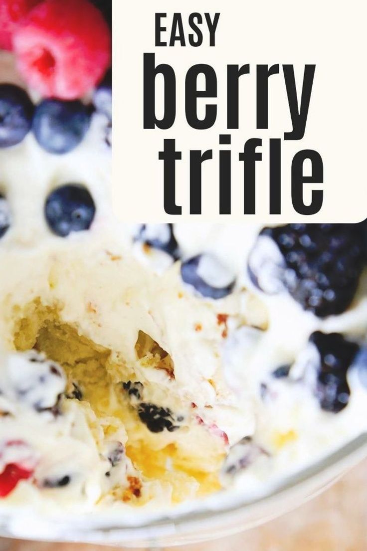 an easy berry trifle recipe in a glass bowl with berries and blueberries on top