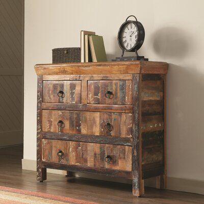 a wooden dresser with drawers and a clock on top