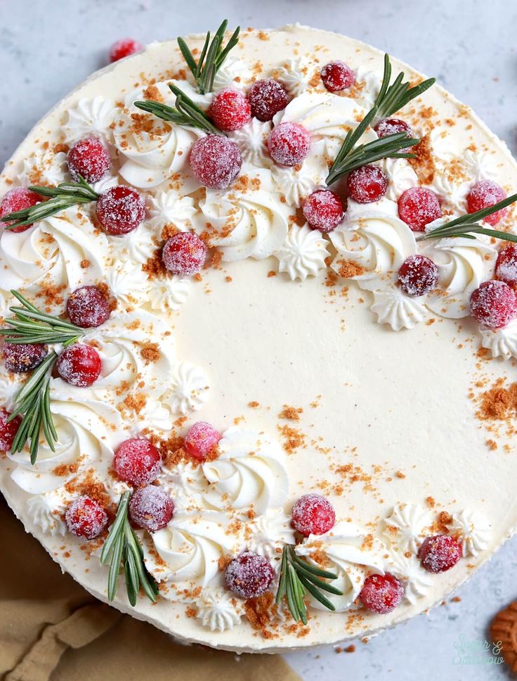 a cake with white frosting and cranberries on top