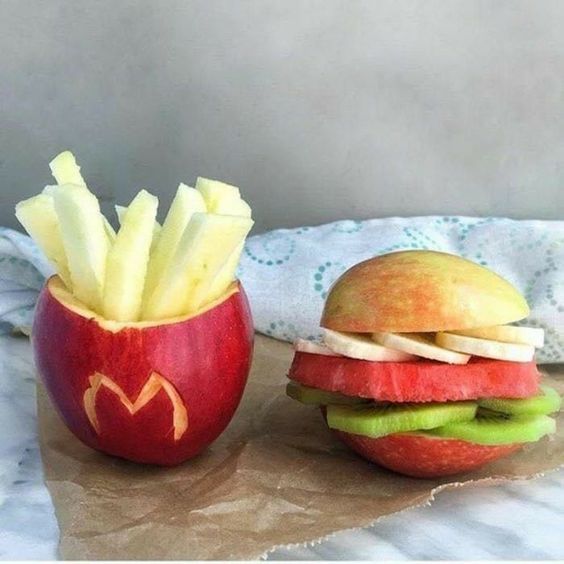 an apple and a hamburger sitting on top of a table