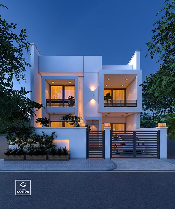 a white two story house with balconies on the second floor and stairs leading up to it