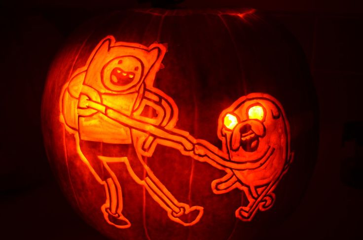 a pumpkin carved to look like an adventure time character