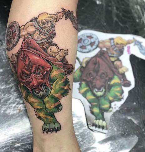 a tattoo on the leg of a person with an image of a demon and other animals