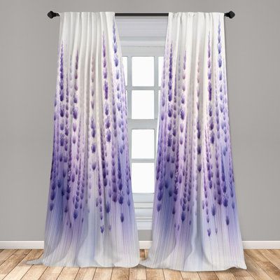 purple and white curtains hanging in front of a window with wood flooring on the side