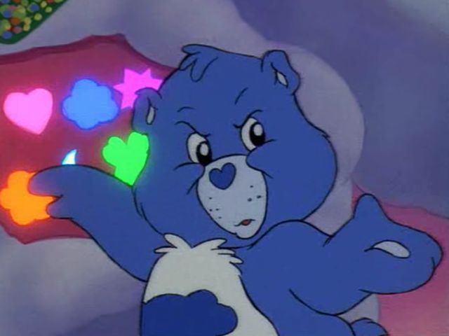 a blue teddy bear with hearts on it's chest