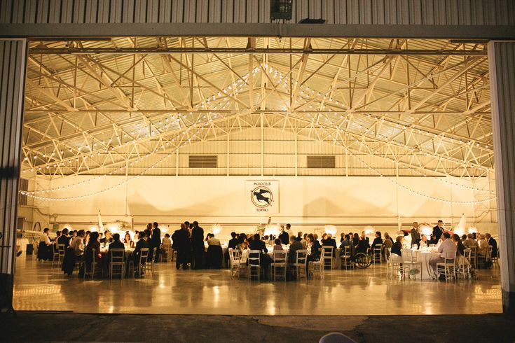 an indoor event with people sitting at tables