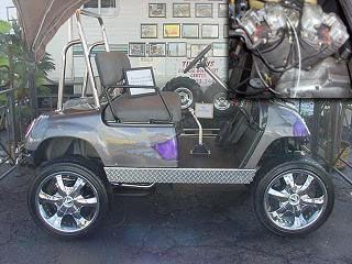 a silver golf cart parked in front of a building