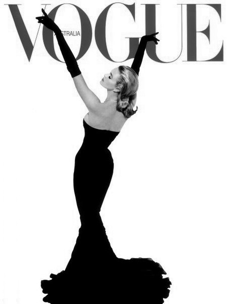 a woman in a black dress on the cover of a magazine with her arms up