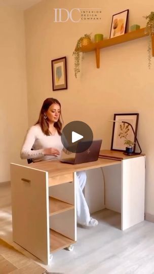 a woman sitting at a desk using a laptop computer