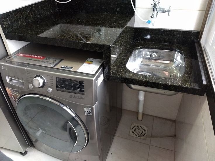 a washer and dryer sitting in a small room next to a counter top