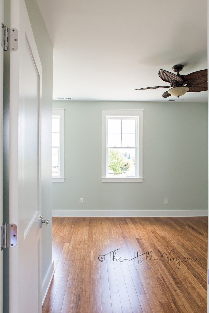 an empty room with hard wood floors and a ceiling fan