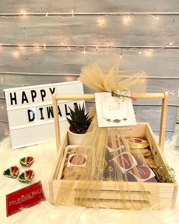 a wooden box filled with assorted candies next to a sign that says happy dinner