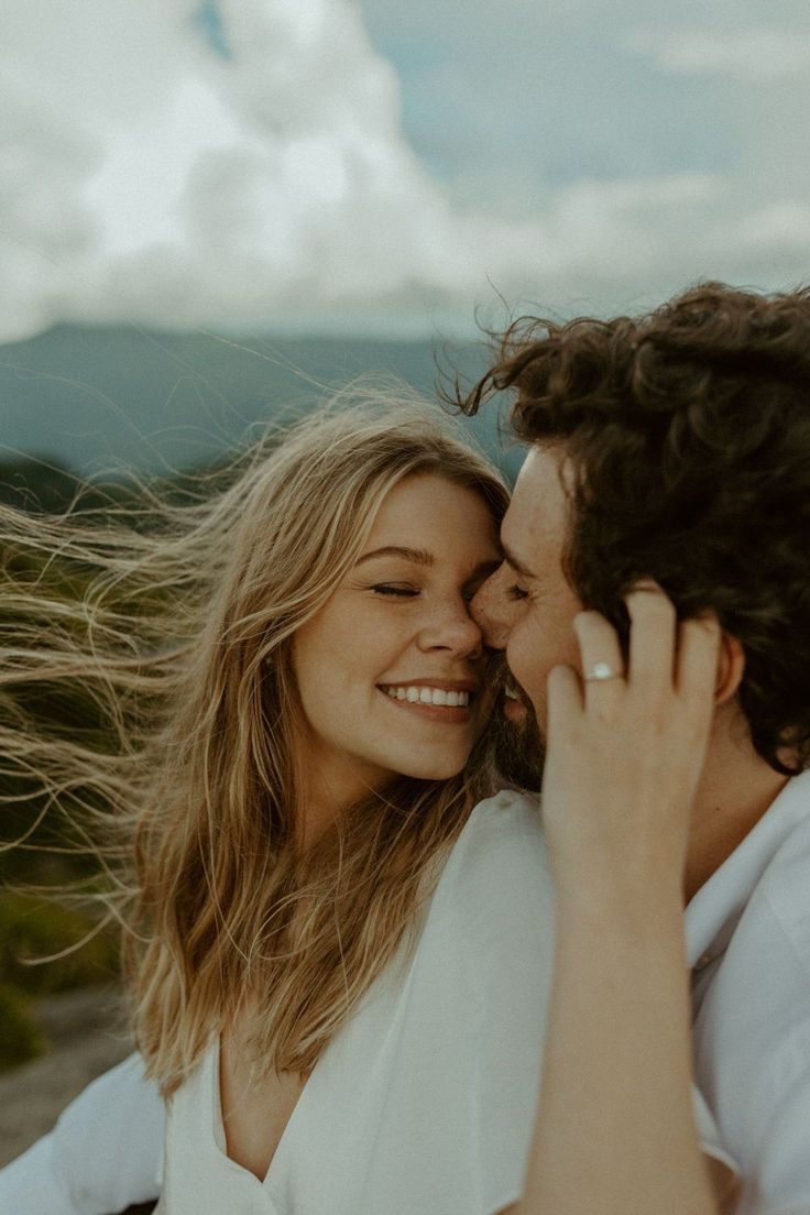 a young man and woman are smiling at each other