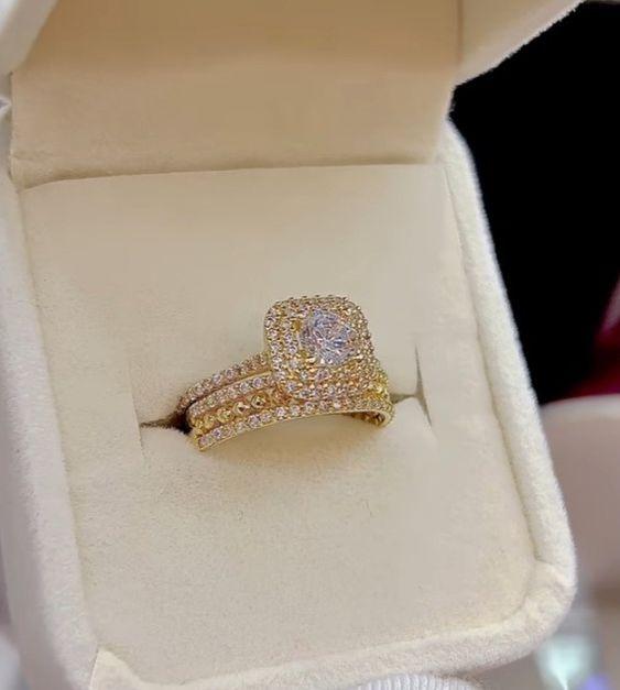 a diamond ring in a white box with its lid open to show it's inside