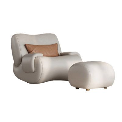 a white chair and foot stool with brown pillows on it's sides, sitting next to each other