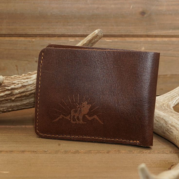 Beautifully made, genuine deer Leather wallets stamped with our Antler Rings Elk logo for an added touch of rustic. Handmade design, and the perfect necessity for any true outdoorsman or huntsman. Available in a traditional Bifold, or Trifold design and plenty of interior pockets for cash, cards, and more! ABOUT THIS ITEM Material: Deer Leather Open Length: 9.5 inches Width: 4.25 inches Handmade Rustic Wallet For Everyday Use, Western Leather Wallet, Ariat Mens Wallets, Western Style Brown Leather Wallet, Artisan Hand-tooled Leather Trifold Wallet, Antler Ring, Gift Accessories, Handmade Design, Antlers