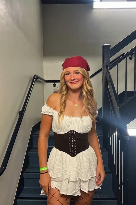 a woman in a pirate costume standing on the stairs