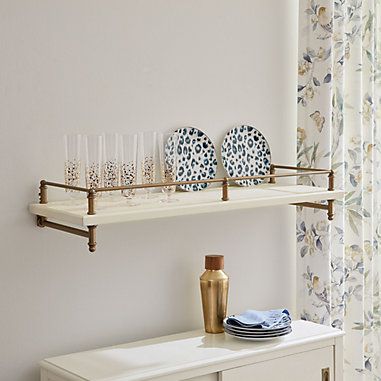 two shelves with glasses and plates on them