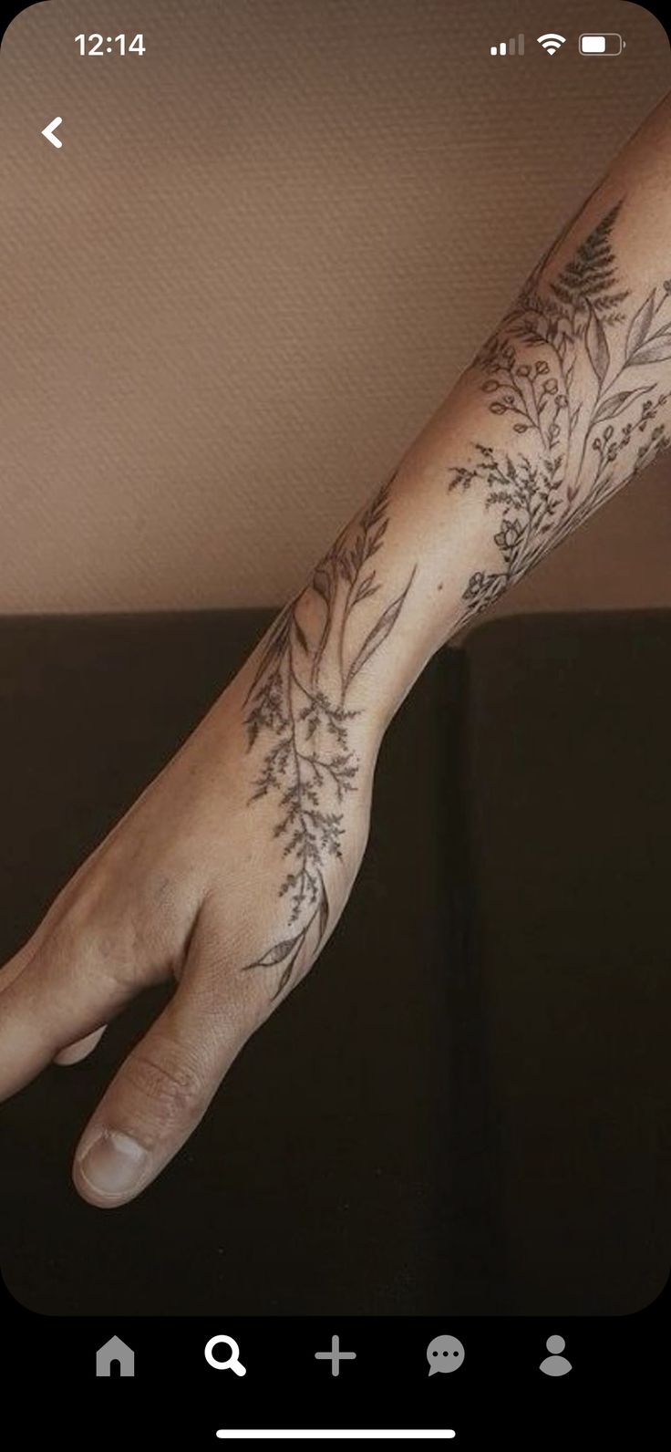 a person's arm with tattoos on it and an image of a plant in the middle