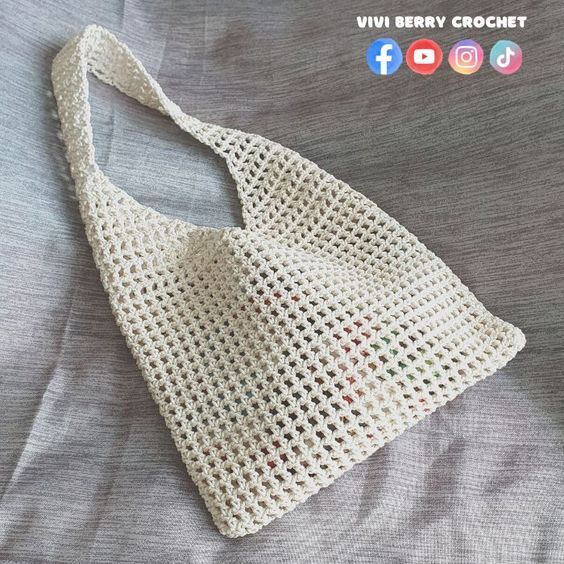 a crocheted bag sitting on top of a bed