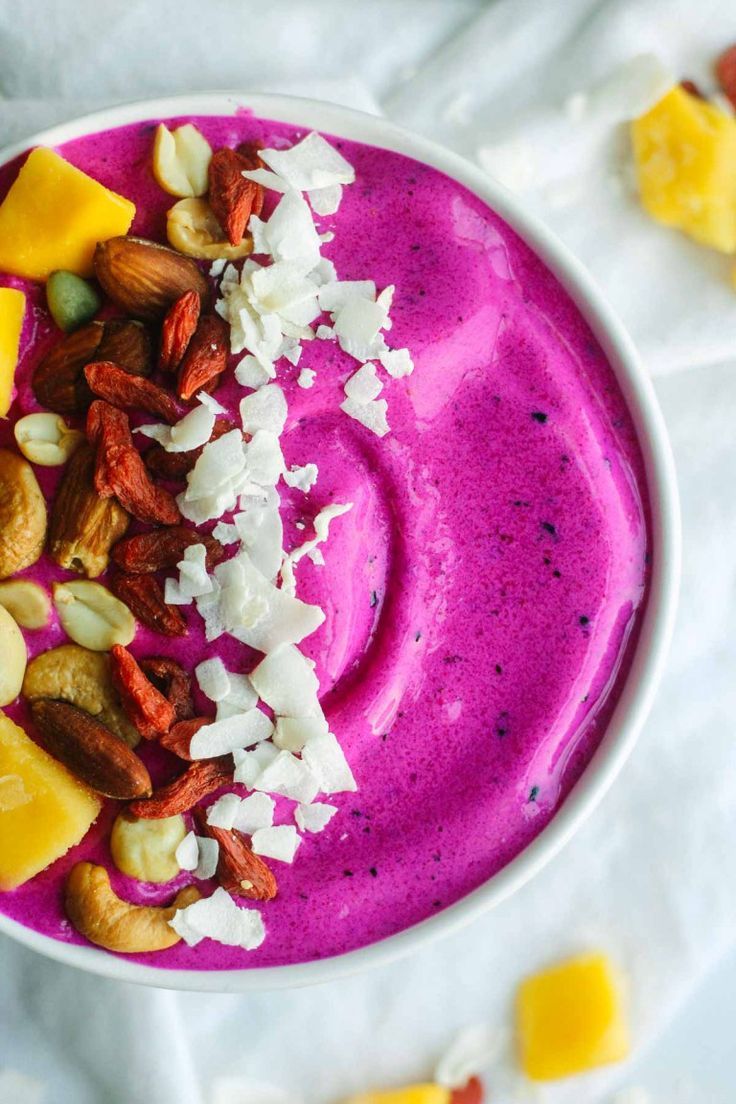 a bowl filled with fruit and nuts on top of a table