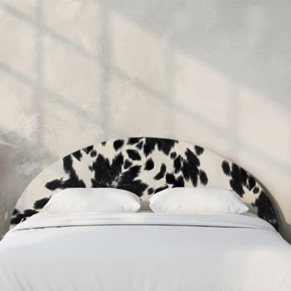 a cow print headboard on a white bed