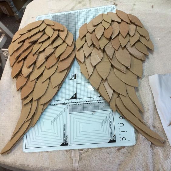 two cardboard angel wings sitting on top of a table