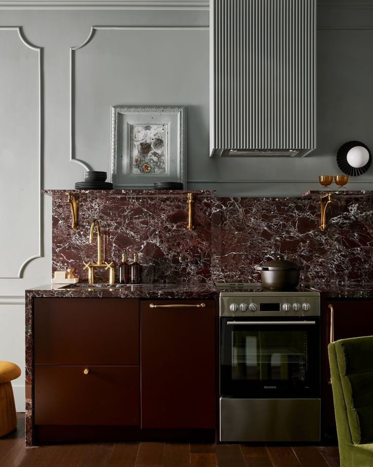 a kitchen with marble counter tops and wooden flooring next to a stove top oven