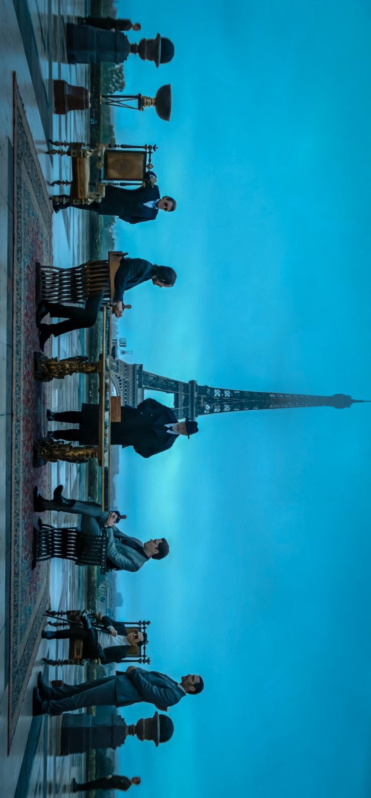 several people standing in front of the eiffel tower