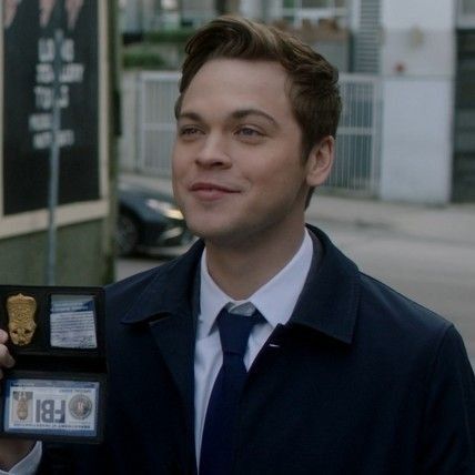 a man in a suit and tie holding an award