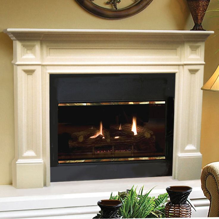 a living room with a fire place in the center and a clock on the wall