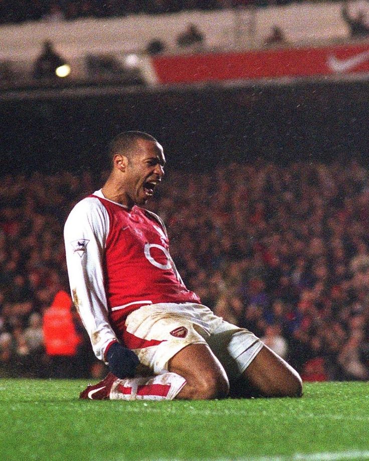 a man sitting on top of a soccer field