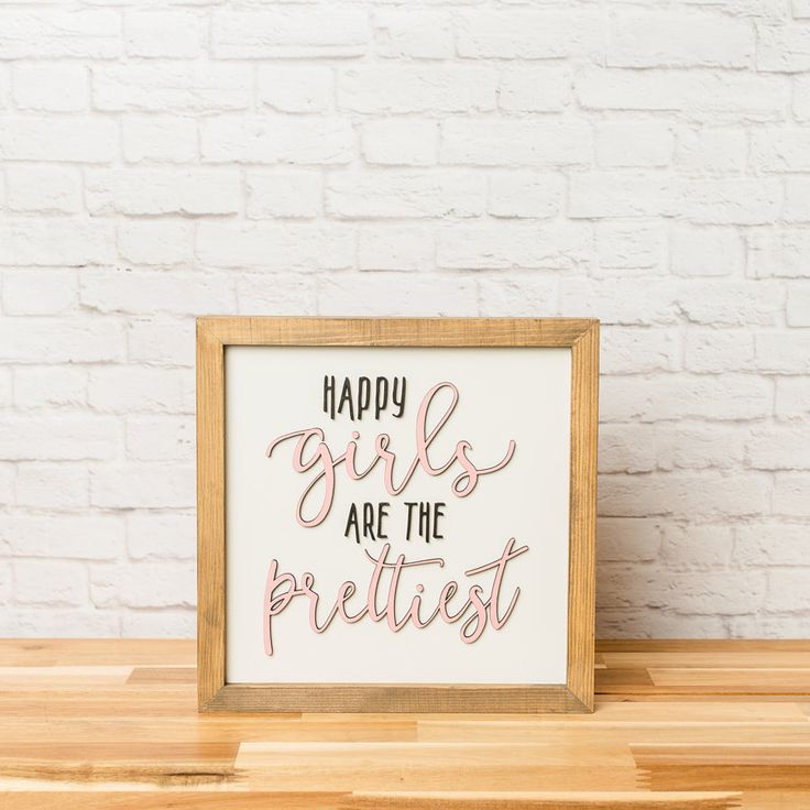 a wooden frame with the words happy girls are the prettiest written in pink