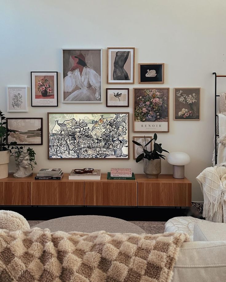 a living room filled with furniture and lots of pictures on the wall above it's coffee table