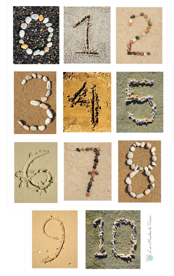 the word love written in sand with rocks and stones around it, including one letter