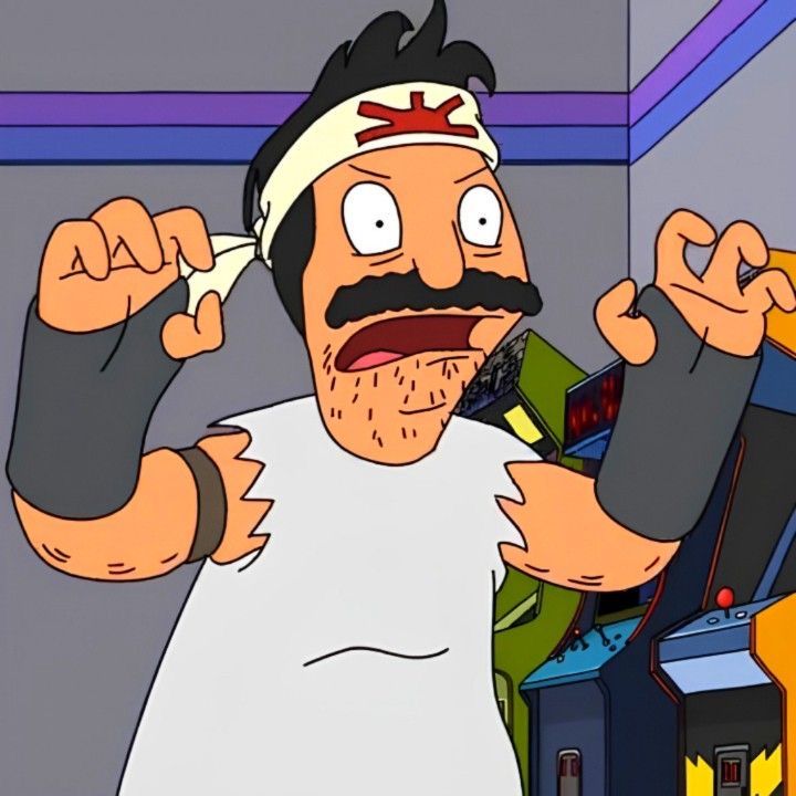 a man with a mustache is holding something in his hand