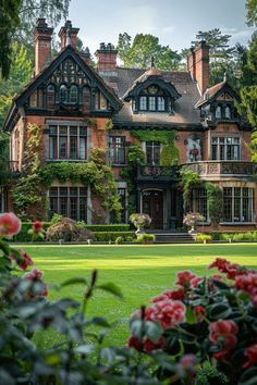 a large house with many windows and lots of greenery on the front lawns