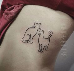 a woman with a cat tattoo on her stomach and the bottom part of her lower back