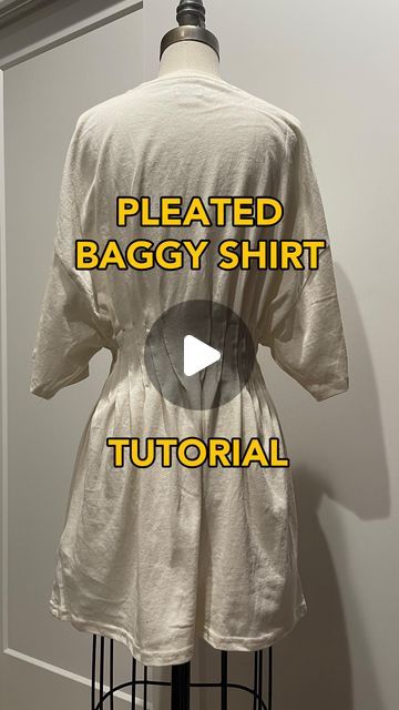 a white shirt with the words pleated baggy shirt in yellow and black on it