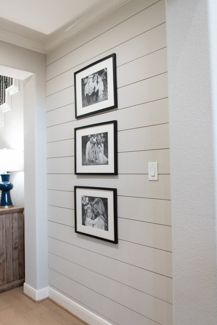 three black and white pictures hanging on the wall