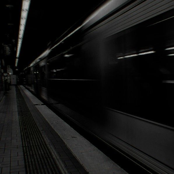 a black and white photo of a train at night