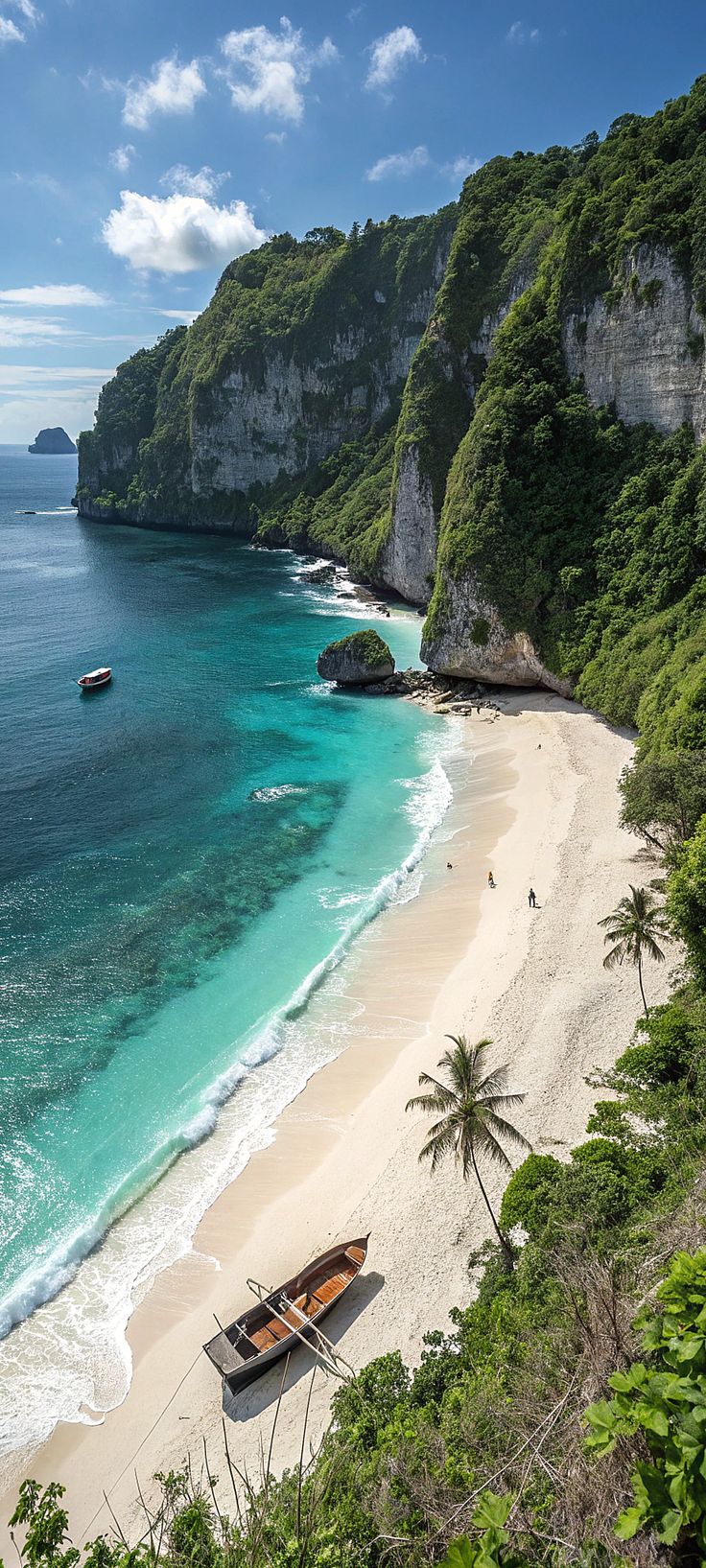 a boat is sitting on the beach next to some trees and water with cliffs in the background