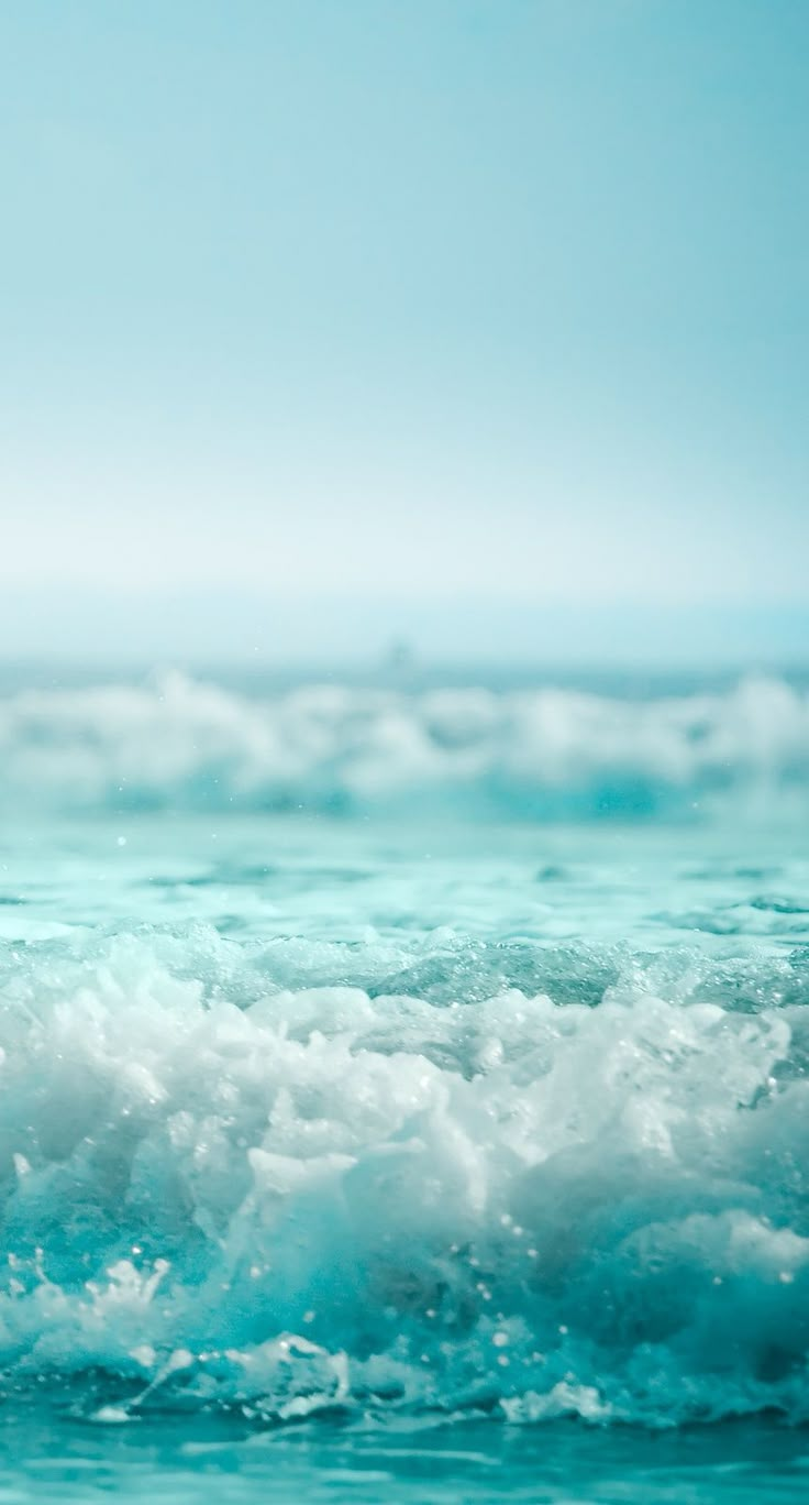 a man riding a wave on top of a surfboard