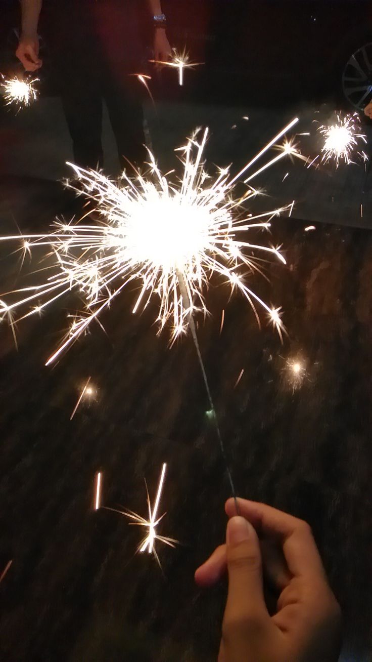 someone is holding a sparkler in their hand